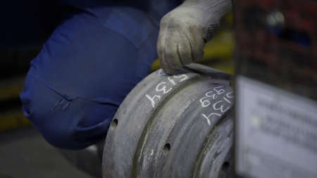 Engineer writes the serial number to die for production aluminium metal profiles. Production of Complex lightweight extruded aluminium metal profilesの写真素材