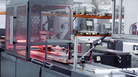 Modern automatic conveyor line for the production of package. Modern factory of production cardboard...