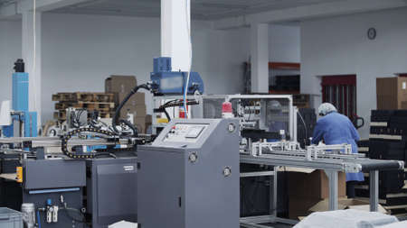 Modern automatic conveyor line for the production of package. Modern factory of production cardboard...