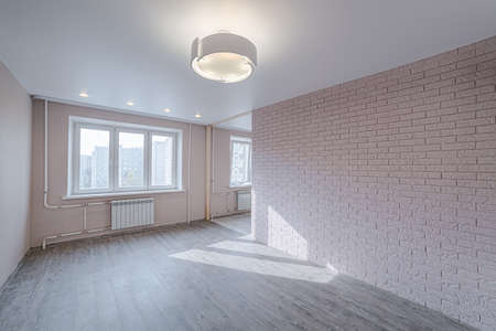 Finishing apartment interior. Empty room in new building with repair, pink walls. Repair works on construction site of residential apartment.の写真素材
