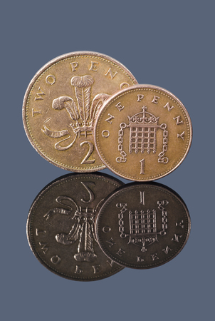 British one penny and two pence on dark background