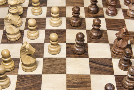 Wooden chessboard with figures closeup