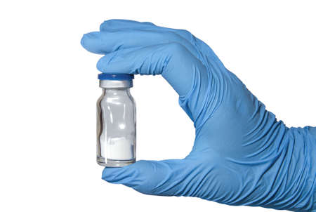 Gloved medic's hand with powder vaccine vial. Healthcare and medication