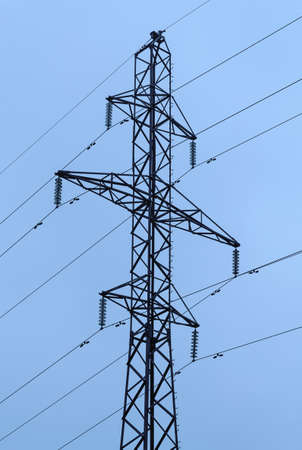 Pylon of power line against light blue background. Electricity, industrial and technologies