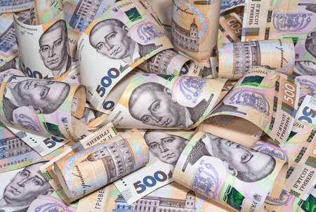 Heap of five hundred hryvnia banknotes of a new sample. Money, business and finance