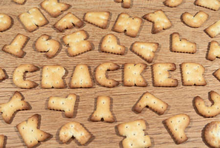 Biscuits in the shape of the letters on a wooden kitchen table. bakery productsの写真素材