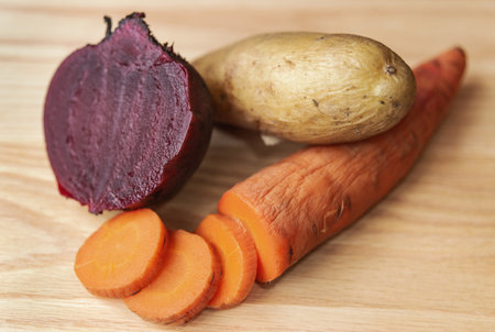 Boiled carrots, beets and potatoes on the kitchen table. Vegetables and fruitsの写真素材