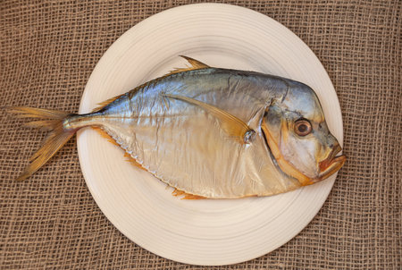 Smoked fish selene vomer on a porcelain plate. Fish and seafoodの写真素材