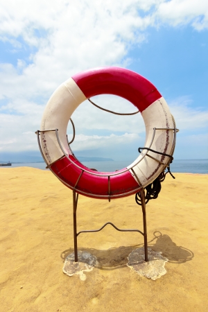 White life buoy with rope on the beachの写真素材