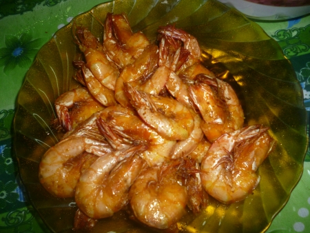 fried prawn marinated with turmeric inside the yellow plate, top viewの写真素材