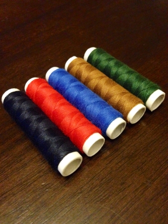 A row of colorful threads on a table