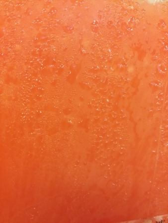 Cold orange softdrink in a container の素材