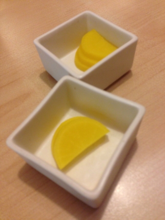 Japanese yellow radish served on white square bowlの素材