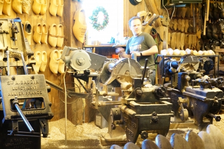 Zaanse Schans; Amsterdam - Holland Wooden Shoe Factory; man demonstrating on how clog was madeのeditorial素材