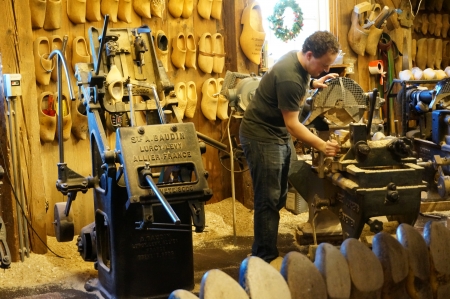 Zaanse Schans; Amsterdam - Holland Wooden Shoe Factory; man demonstrating on how clog was madeのeditorial素材