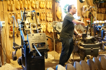 Zaanse Schans; Amsterdam - Holland Wooden Shoe Factory; man demonstrating on how clog was madeのeditorial素材