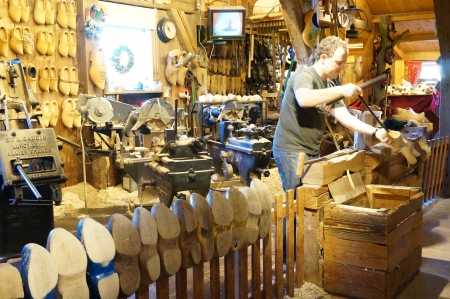 Zaanse Schans; Amsterdam- Holland Wooden Shoe Factory; man demonstrating on how clog was madeのeditorial素材