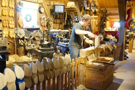 Zaanse Schans; Amsterdam - Holland Wooden Shoe Factory; man demonstrating on how clog was madeのeditorial素材