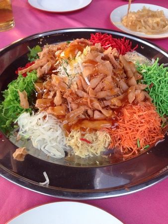 Pouring plum sauce into Colorful Yee Sang の素材