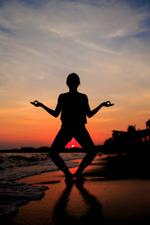 Silhouette of a Woman Beach at sunsetの写真素材