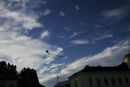 Small kite flying under big blue sky の素材