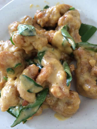 Salted egg chicken on a plateの素材