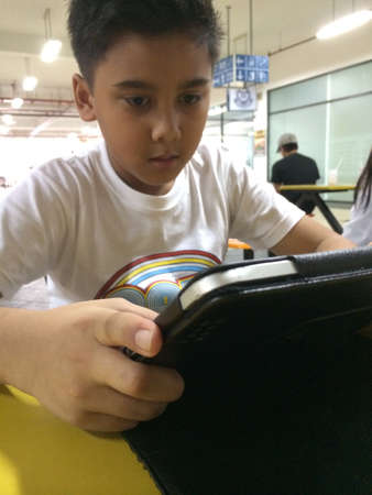 Little boy playing tablet
