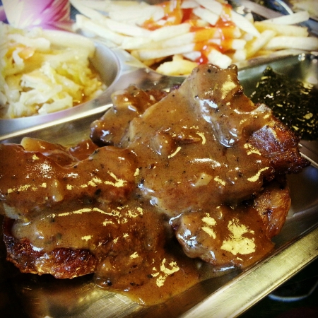 Close Up of lamb chop served with mushroom sauce and mint sauceの素材