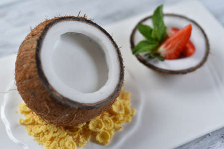 coconut dessert with corn flakes and strawberries in coconut