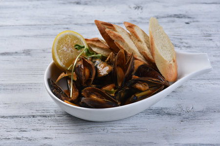 mussels tom yum with croutons and lemonの写真素材