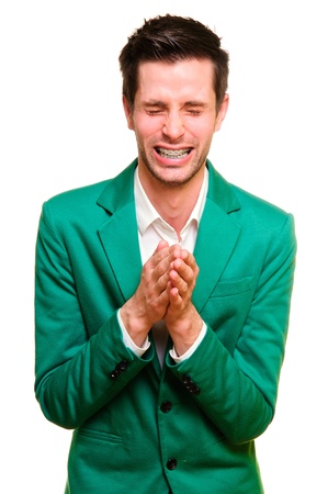 positive emotional young man in a green jacket. making expressive gestures. portrait isolated on white backgroundの写真素材