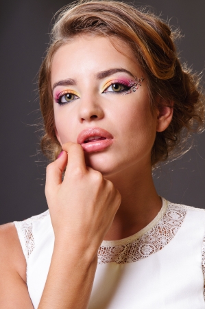 Beautiful woman with volume and shiny curly hair style, bright lips make-up の写真素材