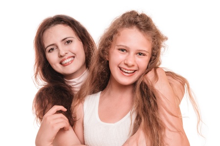 Portrait of young smiling mother with her daughter on the white backgroundの写真素材
