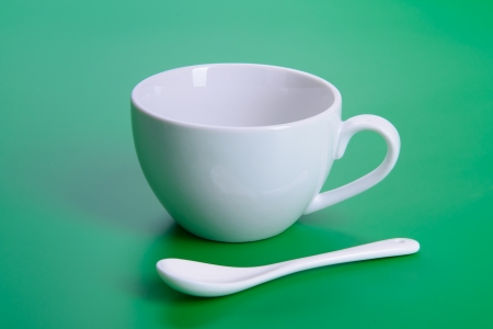 empty white cup on green backgroundの写真素材