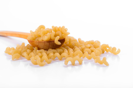 Vermicelli in a wooden spoon on a white background の写真素材