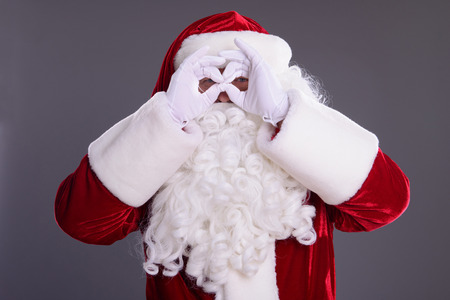 happy Santa Claus shows gesture. on gray backgroundの写真素材