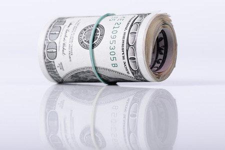 bundle of dollars banknotes on light backgroundの写真素材