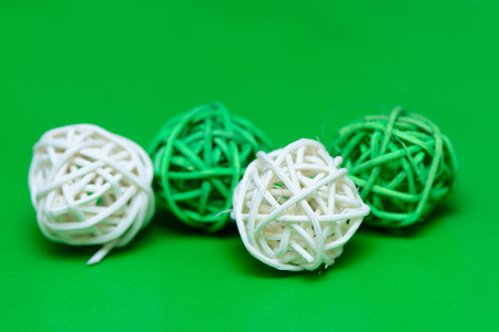 Decorative wooden wicker sphere on a green background closeupの写真素材