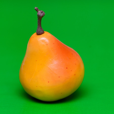 Yellow fresh pear on a green background closeupの写真素材