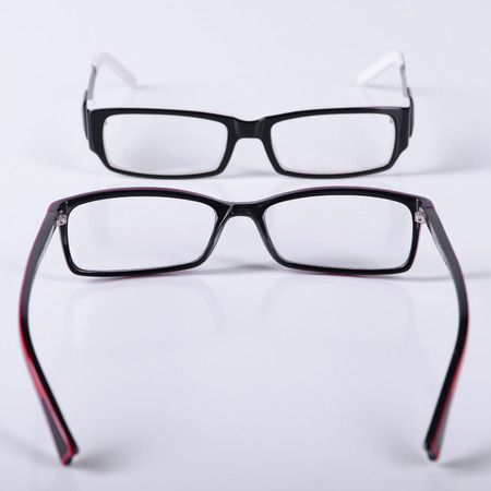 two optical glasses on a light gray background closeup