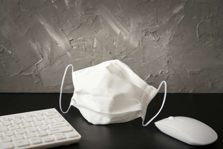 workplace office accessories and face mask - a coronavirus timeの写真素材