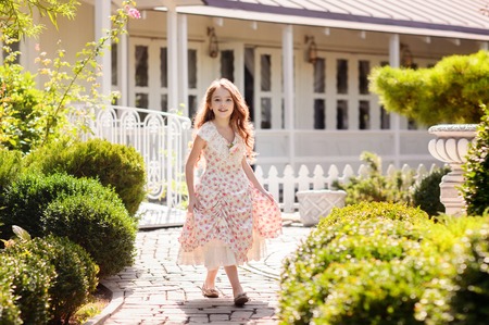 Charming redhead girl. She poses and smiles in the outdoors.の写真素材