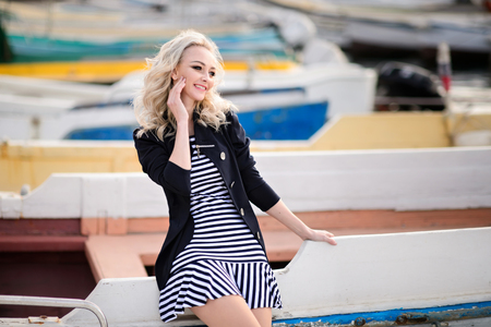 The girl near boats on a marina.の写真素材