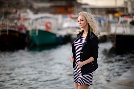 The girl near boats on a marina.の写真素材