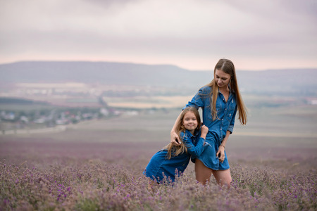 Mom and girl walk on the lavender field.の写真素材