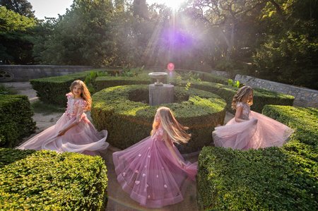 Beautiful young girls in amazing dress outdoor. Children bridesmaidsの写真素材