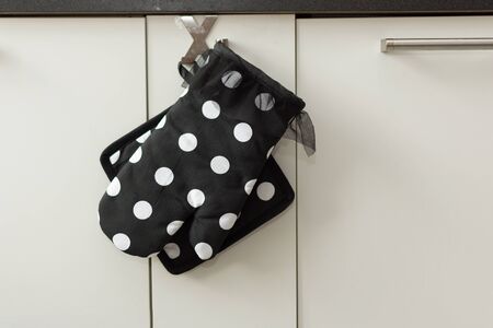 Potholder and an oven mitt in modern kitchen interior. Stylish kitchen mitt.の写真素材