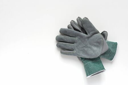 Pair of grey leather work gloves on white background. Protective gloves for working. Copy space.の写真素材