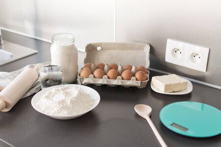 Food ingredients for baking: flour, eggs, milk, sugar. Process of baking.の写真素材