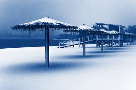 Snowy winter beach in a modern classic blue color of 2020 year. Winter background.の写真素材